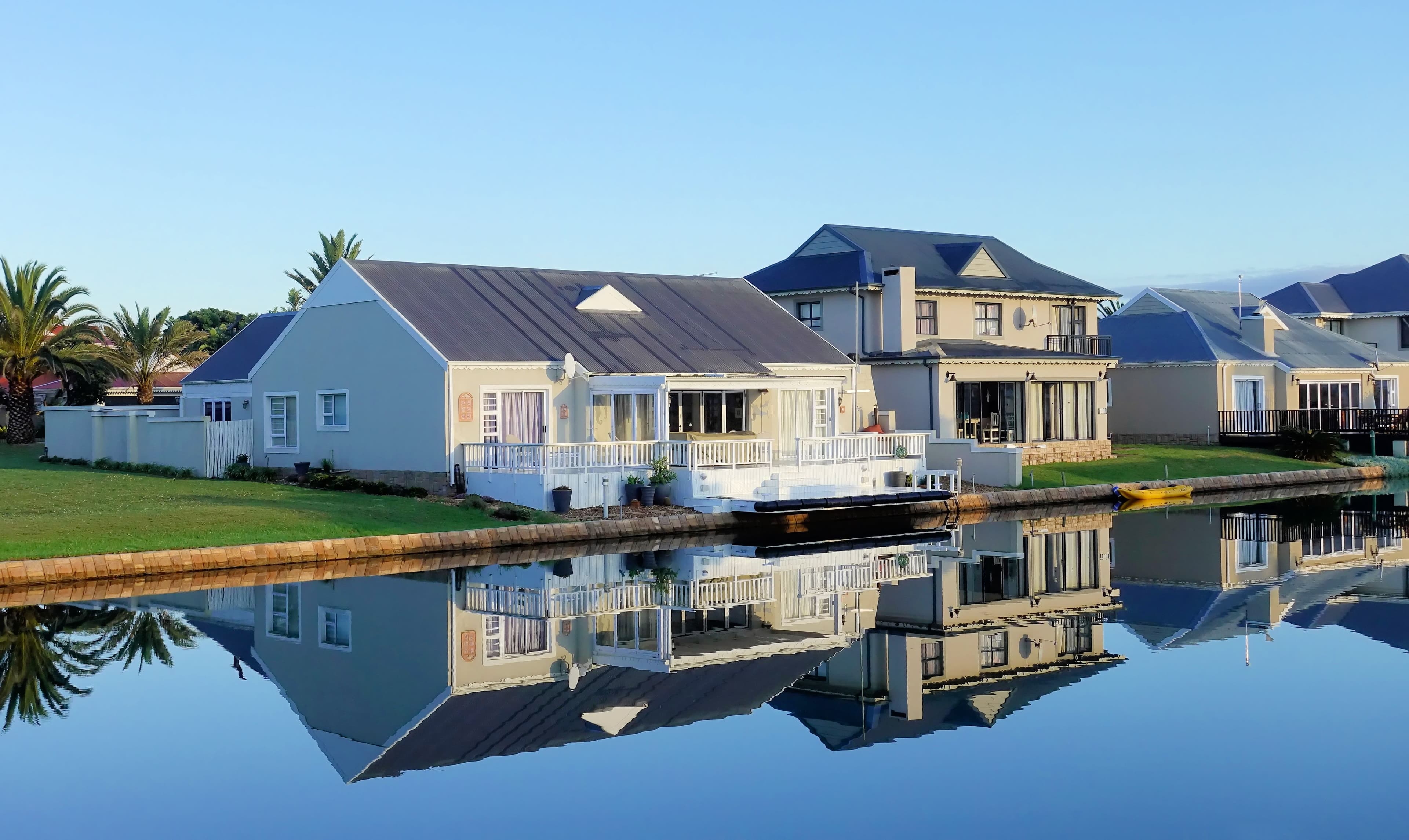 Waterfront houses reflected in a calm canal